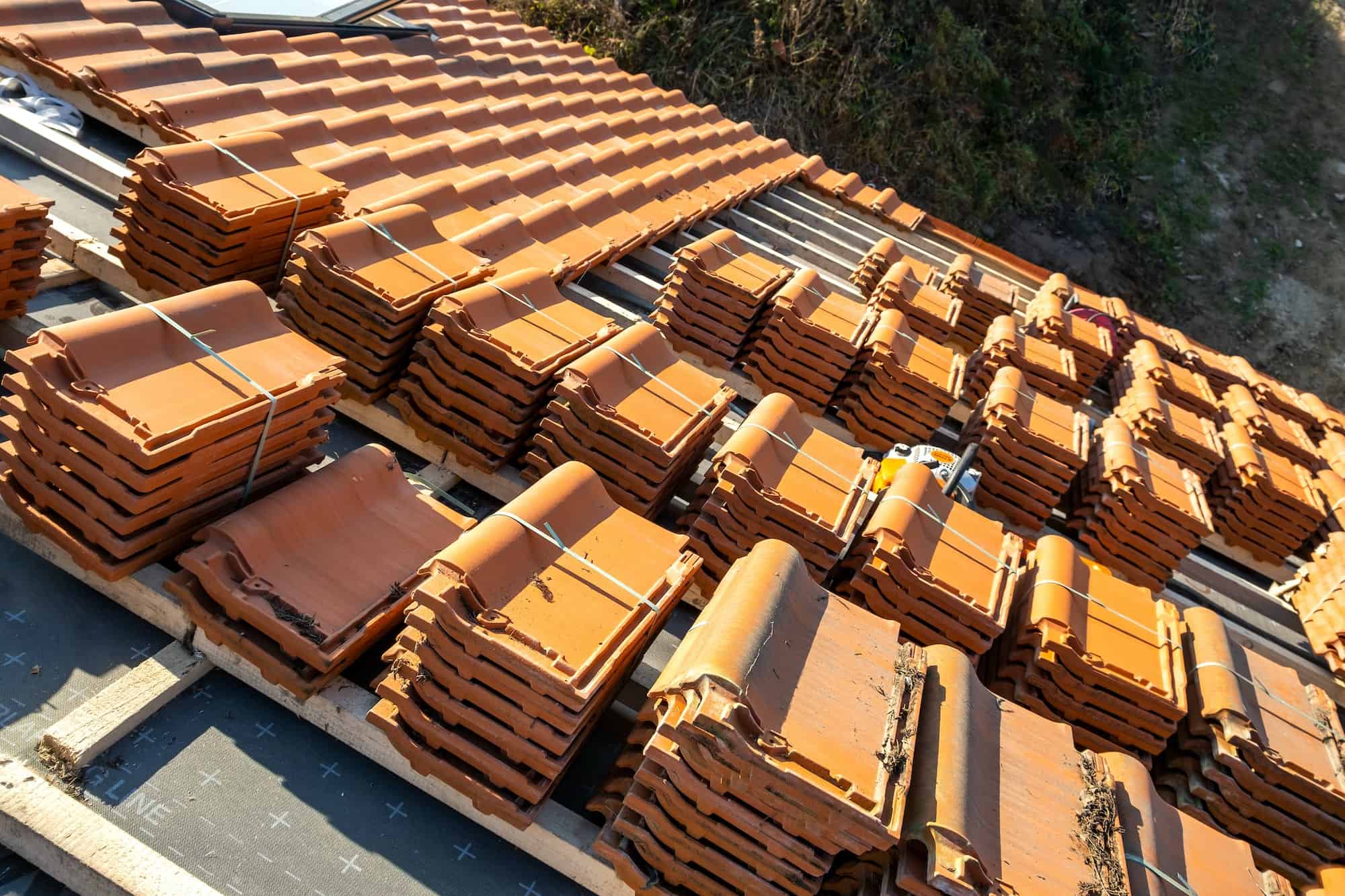stacks-of-yellow-ceramic-roofing-tiles-for-covering-residential-building-roof-under-construction.jpg